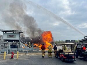 Four fireman observing a fire at the Brayton Fireman's Training Center.