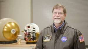 Photo of Dr. Rob Ambrose with a Roboball in the background.